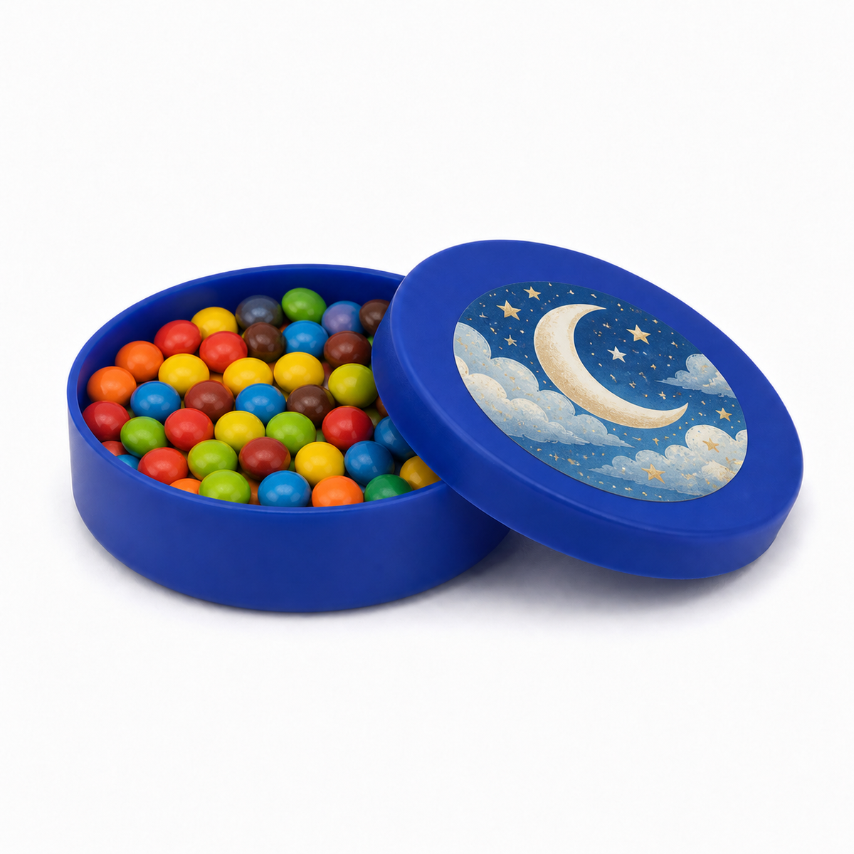 Dark blue mini plastic favour tin filled with colourful sweets, with a moon and stars decorated matching lid on a white background